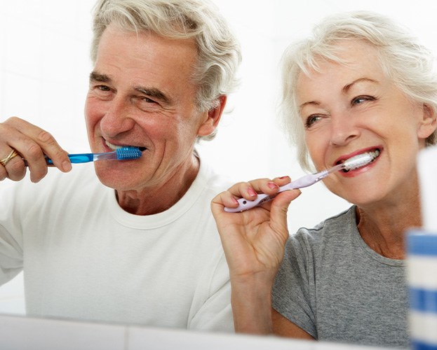 older couple brushing teeth together