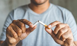 closeup of a man breaking a cigarette