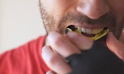 closeup of an amateur boxer putting in a mouthguard