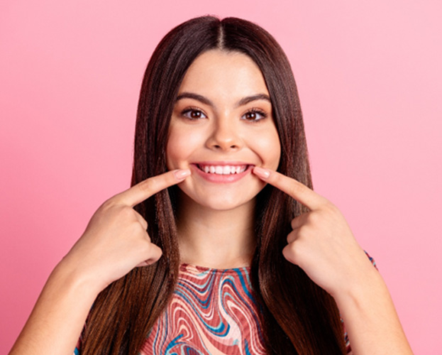 Woman pointing to her teeth
