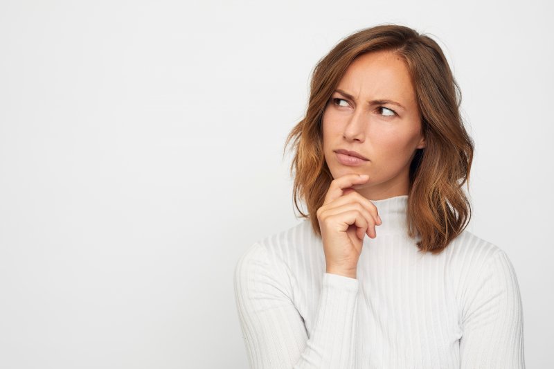 a woman looking to the side pensively